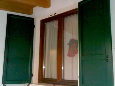 Finestra in legno lamellare, scuri in alluminio RAL a doghe verticali